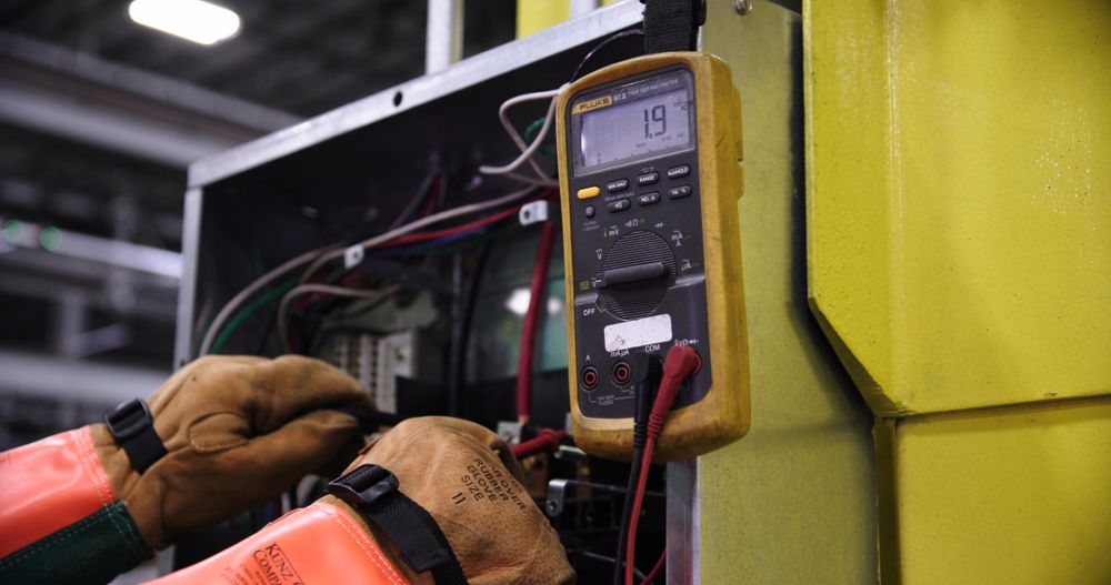 Electrical equipment being checked with a multimeter
